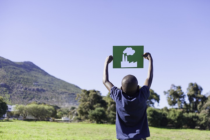 Young African boy holding up a factory cut out. Cape Town, Western Cape, South Africa